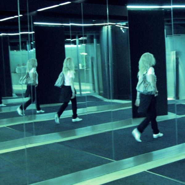 Donna-riflessa-su-specchi-paralleli.jpg